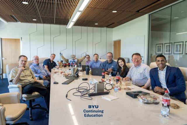 A group of people sitting around a table
Description automatically generated